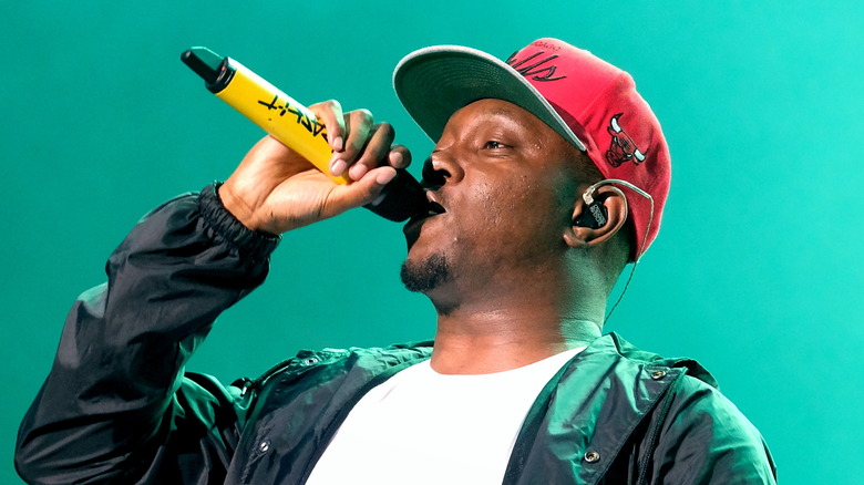 Dizzee Rascal performing into mic