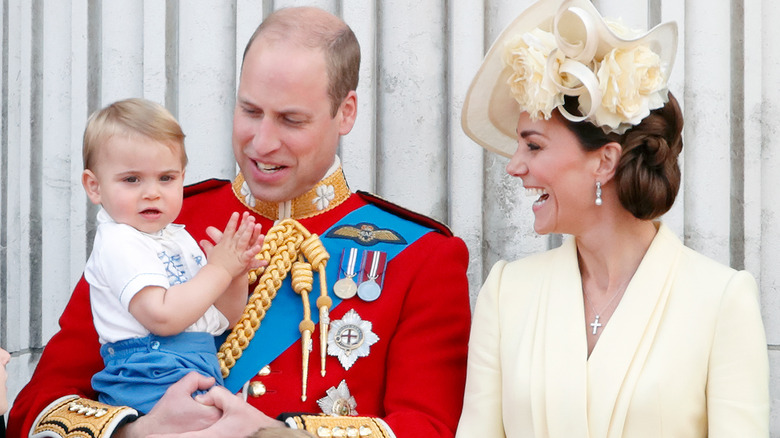 Prince Louis posing with Prince William and Kate Middleton 