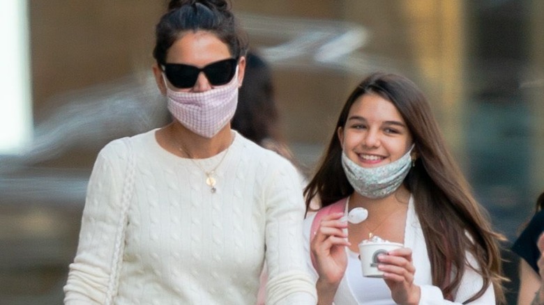 Suri Cruise eating ice cream while strolling with Katie Holmes 