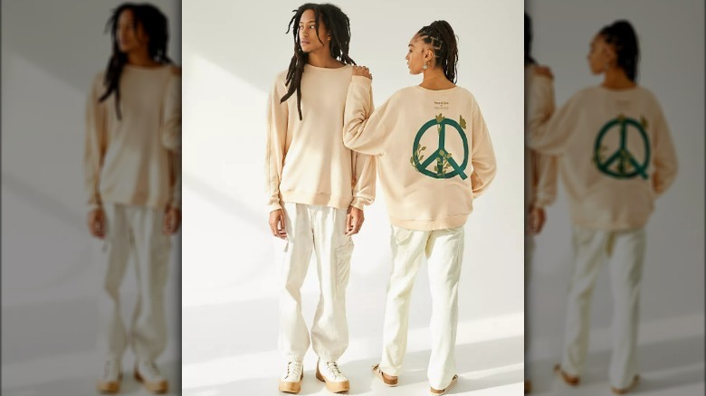 Two models wearing gender-neutral peace sign sweatshirt