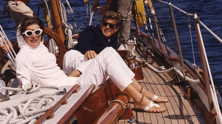 Jackie and John Kennedy on a boat smiling 