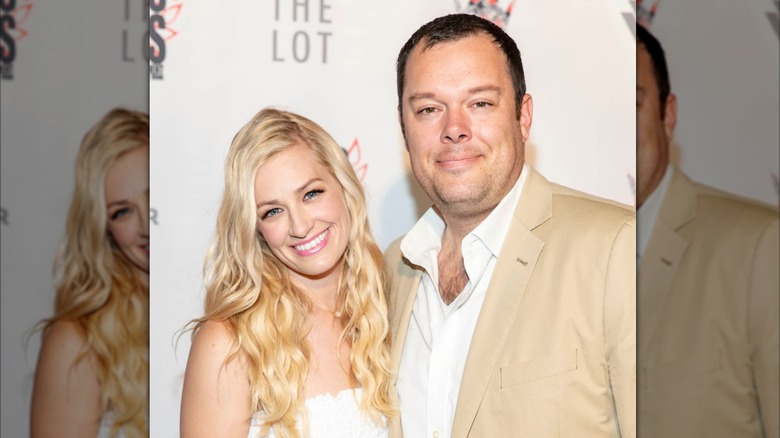 Beth Behrs and her husband Michael Gladis posing at an event