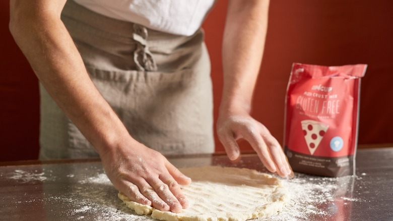 Hand-shaping homemade pizza dough