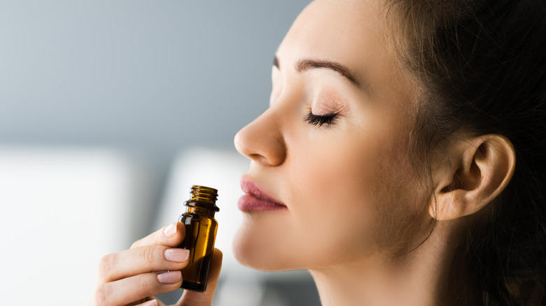 woman smelling essential oils