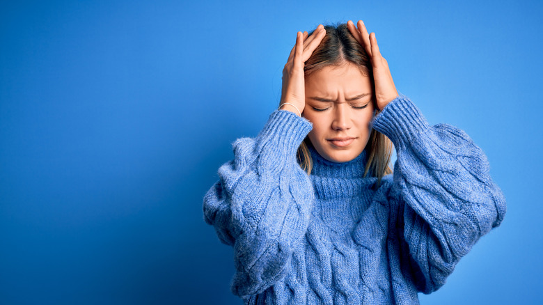 woman having migraine pain