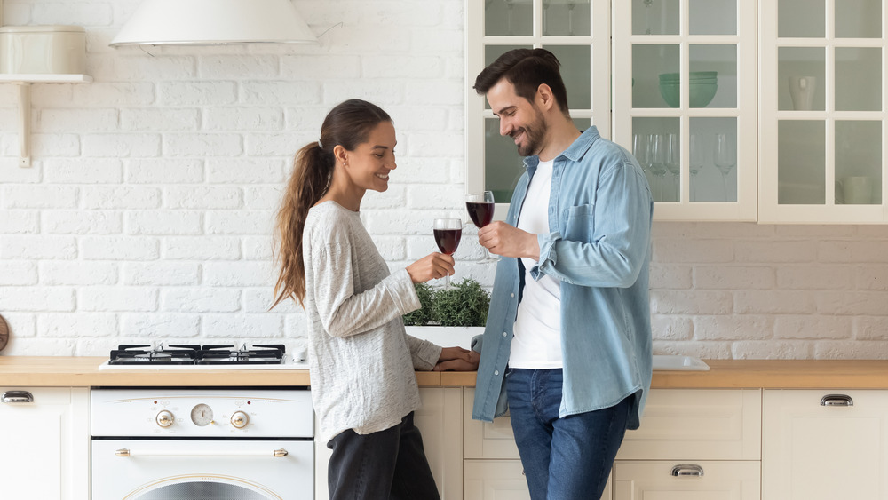 A woman and a man each holding a glass of wine