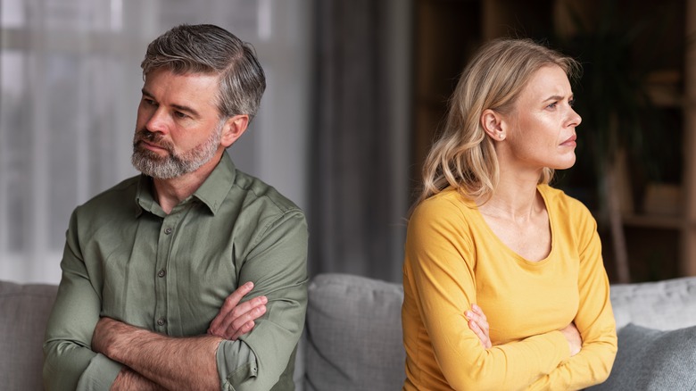 a seated couple who are at odds 