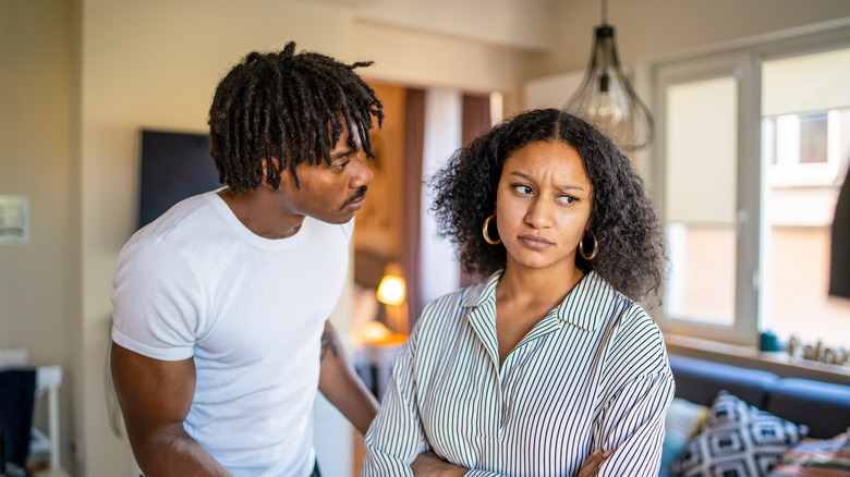 a standing, distressed couple