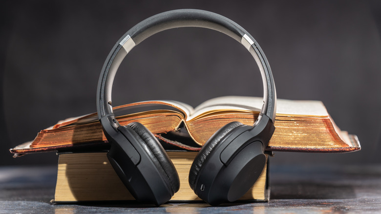 headphones lean against stacked books