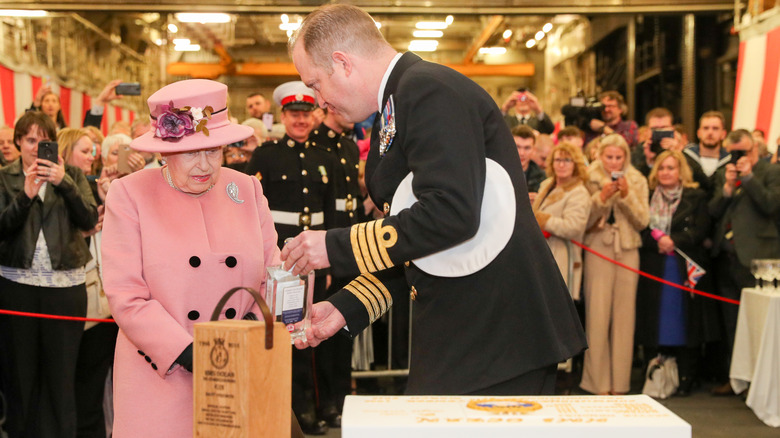 Queen Elizabeth II being presented with gin