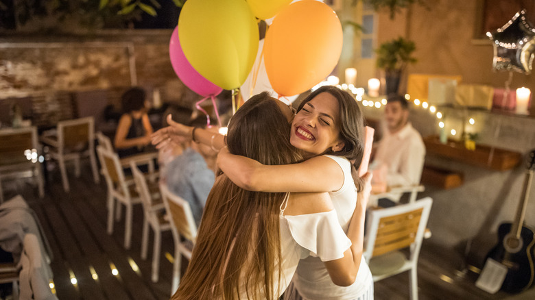 women hugging party