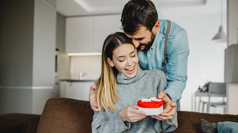 man giving woman gift