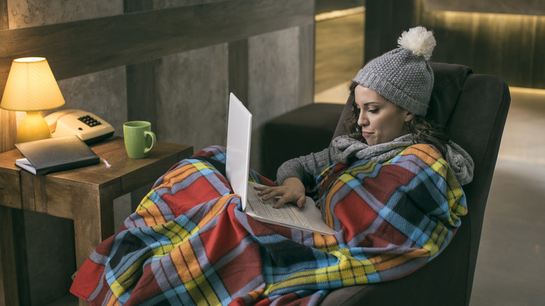 Woman with blanket and laptop