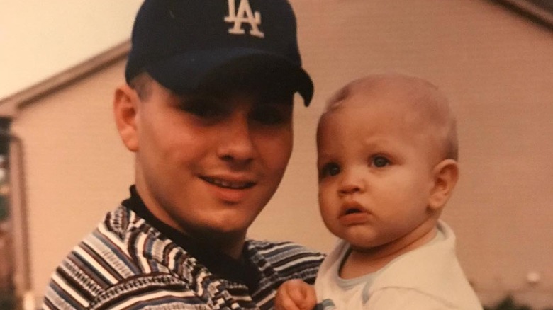 Baby Matt Rife being held by his dad
