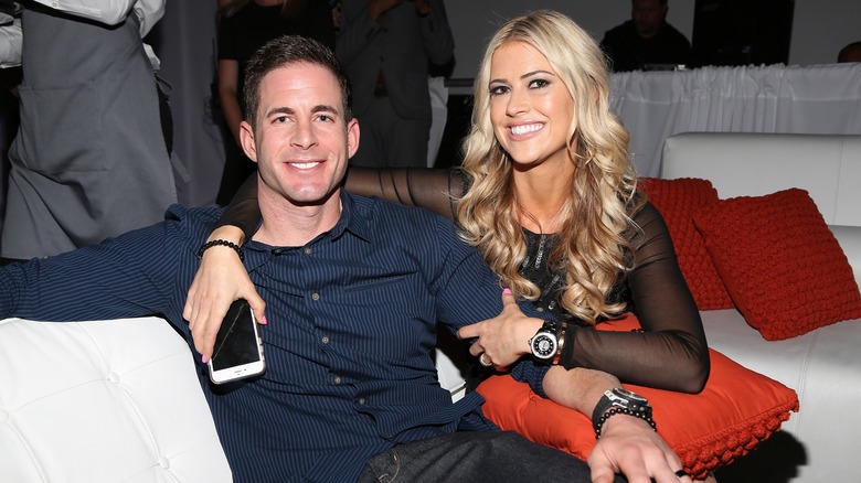 Tarek El Moussa and Christina Hall posing together on a couch in 2016