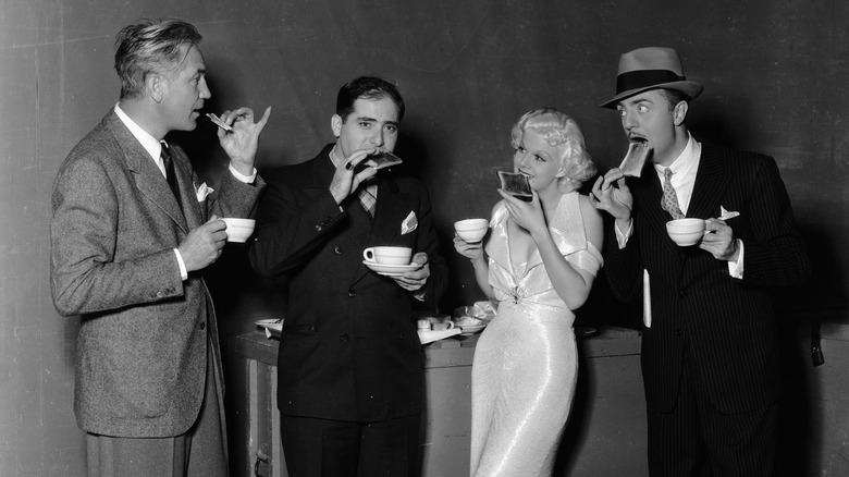 Jean Harlow and others eating toast