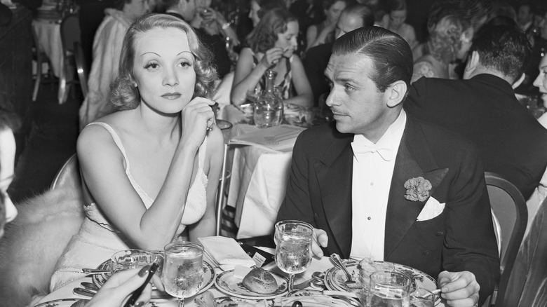 Marlene Dietrich at a table