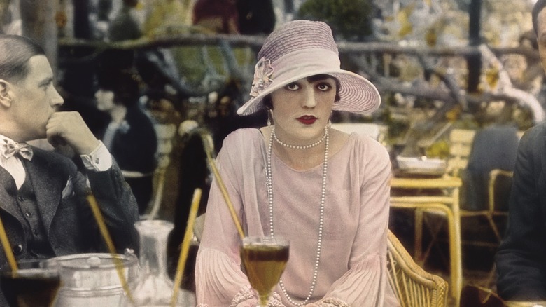 Pola Negri at a table