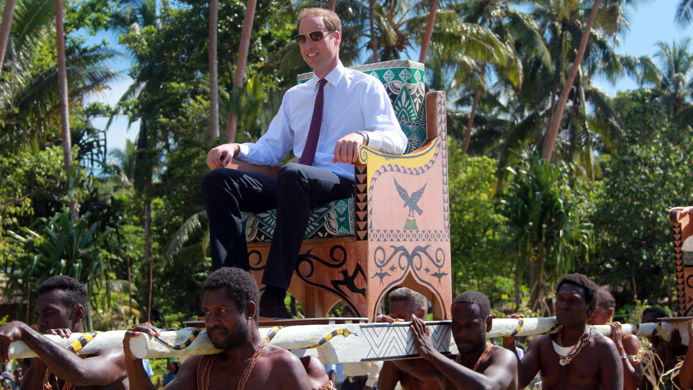 Prince William carried on a throne