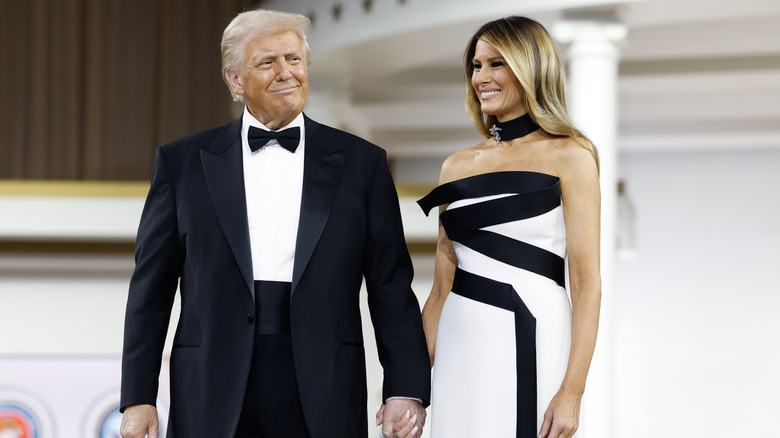 Donald Trump holds hands with wife Melania Trump at an inauguration ceremony on January 20, 2025.