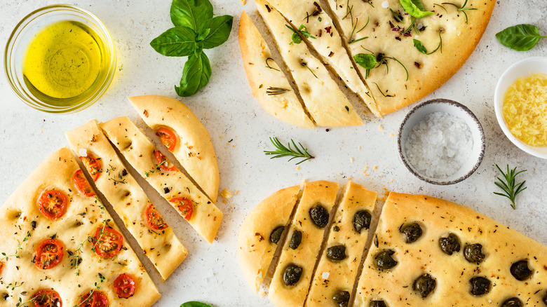 Focaccia breads with fresh herbs and vegetables