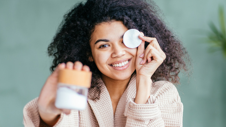 Woman with eye makeup pad