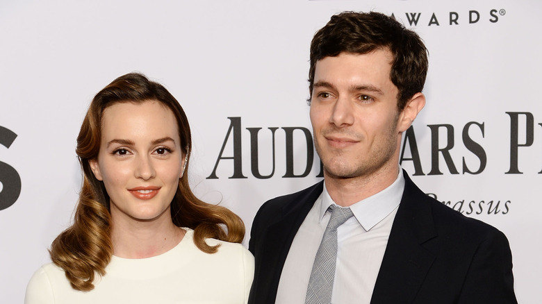 Leighton Meester and Adam Brody smiling for the cameras