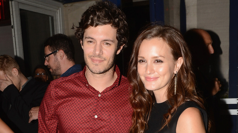 Leighton Meester and Adam Brody posing for the cameras in their younger years