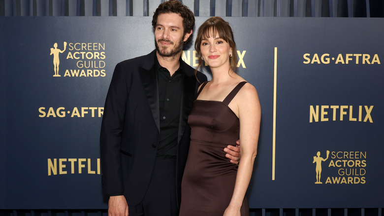 Leighton Meester and Adam Brody smiling on the red carpet