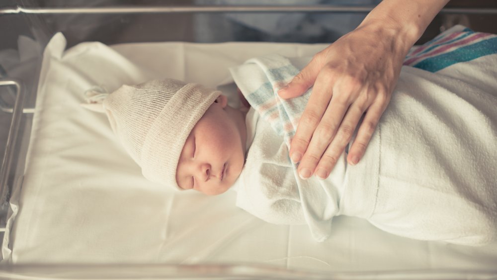 parent checking newborn