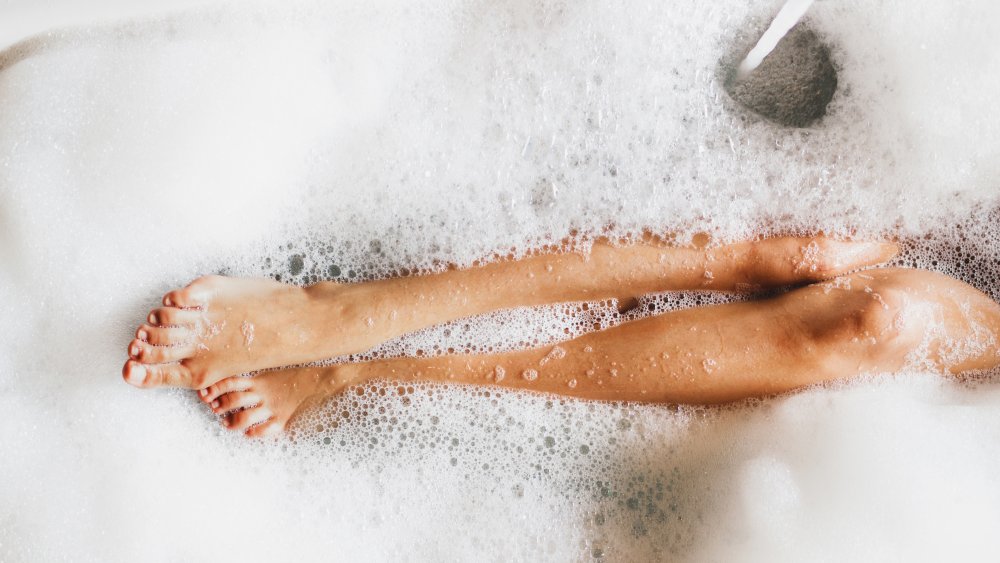 woman's legs in bathtub