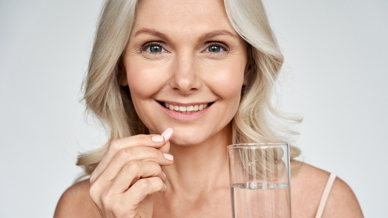 Woman with water and vitamin