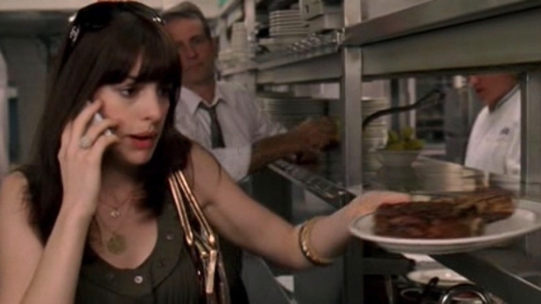 Anne Hathaway with a steak in The Devil Wears Prada