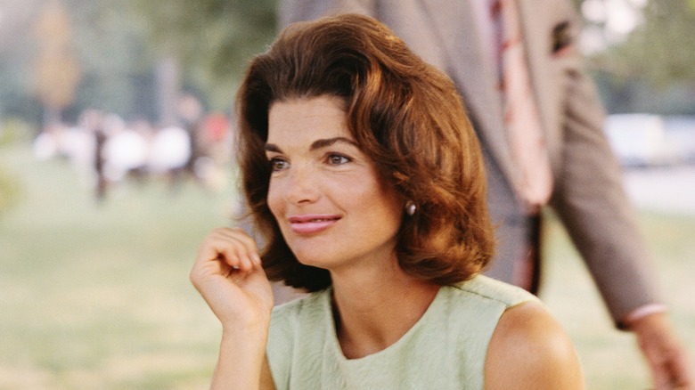 Jackie Kennedy smiling slighty