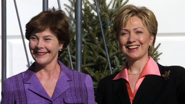 Laura Bush and Hillary Clinton smiling