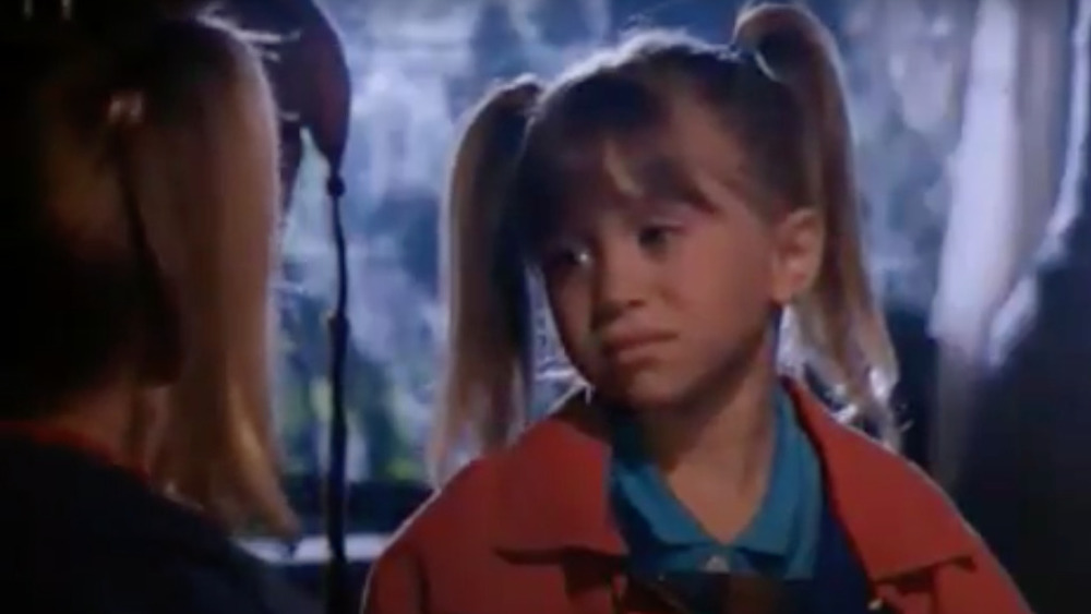 An Olsen twin with pigtails