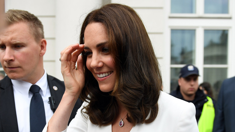 Kate Middleton walking through a crowd