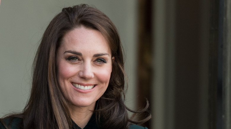 Kate Middleton grinning at an event