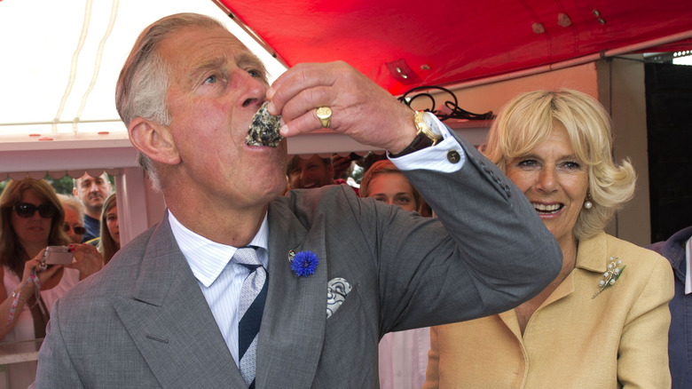 Prince Charles eating an oyster