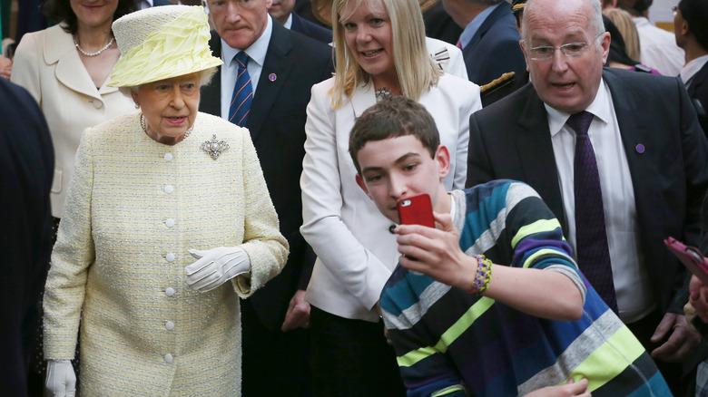 boy taking selfie with Queen