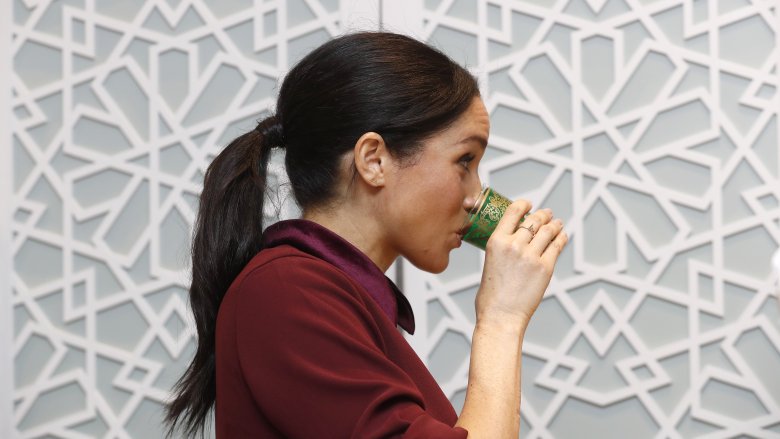 Meghan Markle drinking from a glass