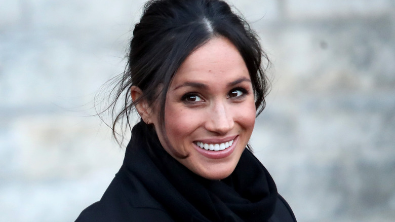 Meghan Markle smiling at the camera