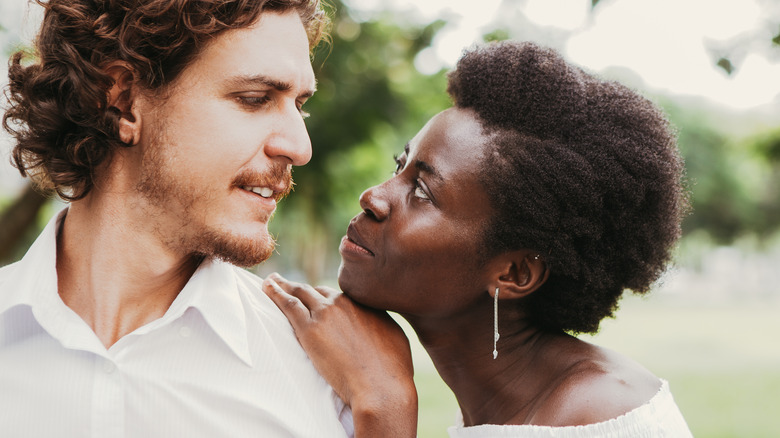 woman leaning on man's shoulder