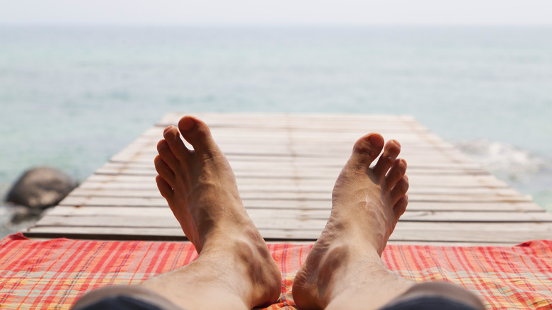 Man's feet on beach