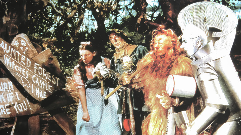 Dorothy, Scarecrow, Lion, and Tin Man in scene from "The Wizard of Oz"