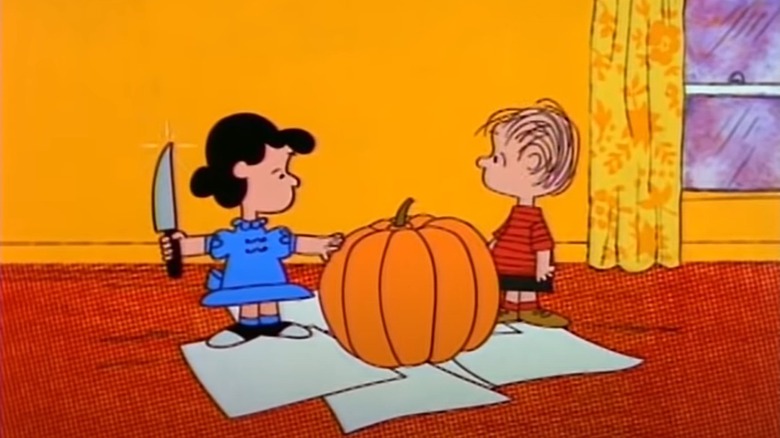 Lucy and Linus carving pumpkin