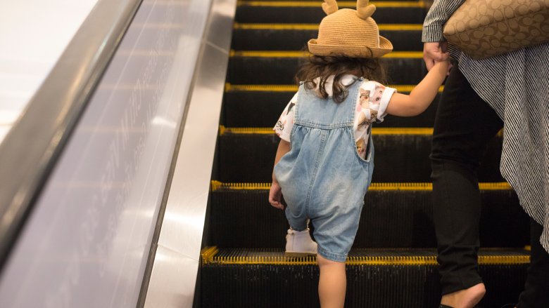 mom and child on escalator