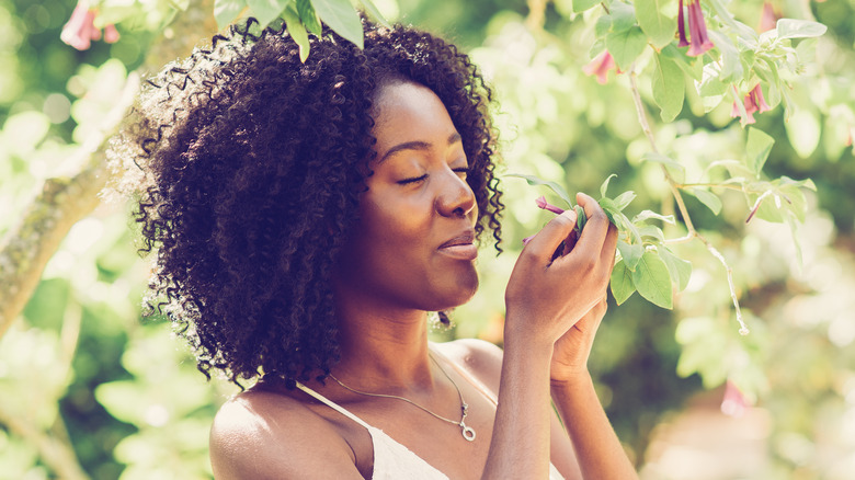 woman smelling a flower