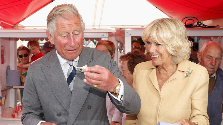 Charles eating oysters with Camilla