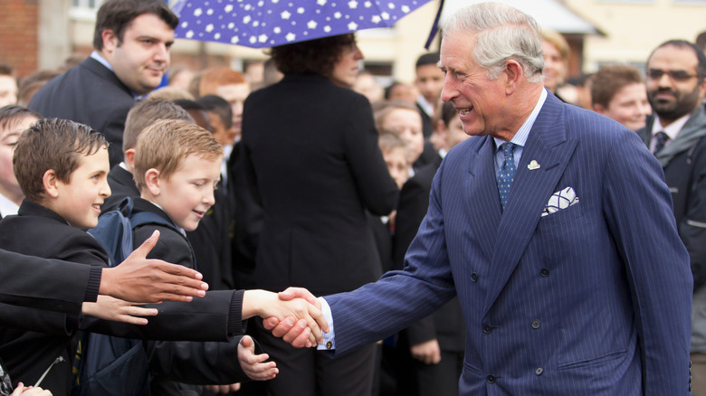 Charles meeting schoolboys during walkabout